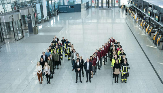 Employees of Munich Airport positioned as an M.