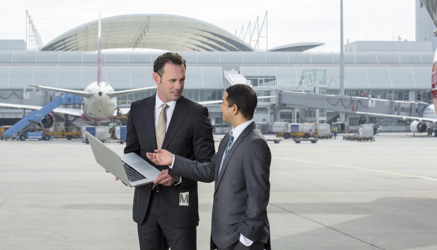 Business men airside Business men with a laptop airside at Munich Airport