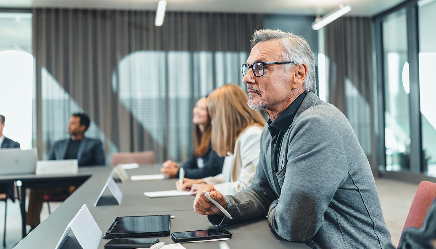 Training participants Group of training participants sitting in a U-shape in a training room.